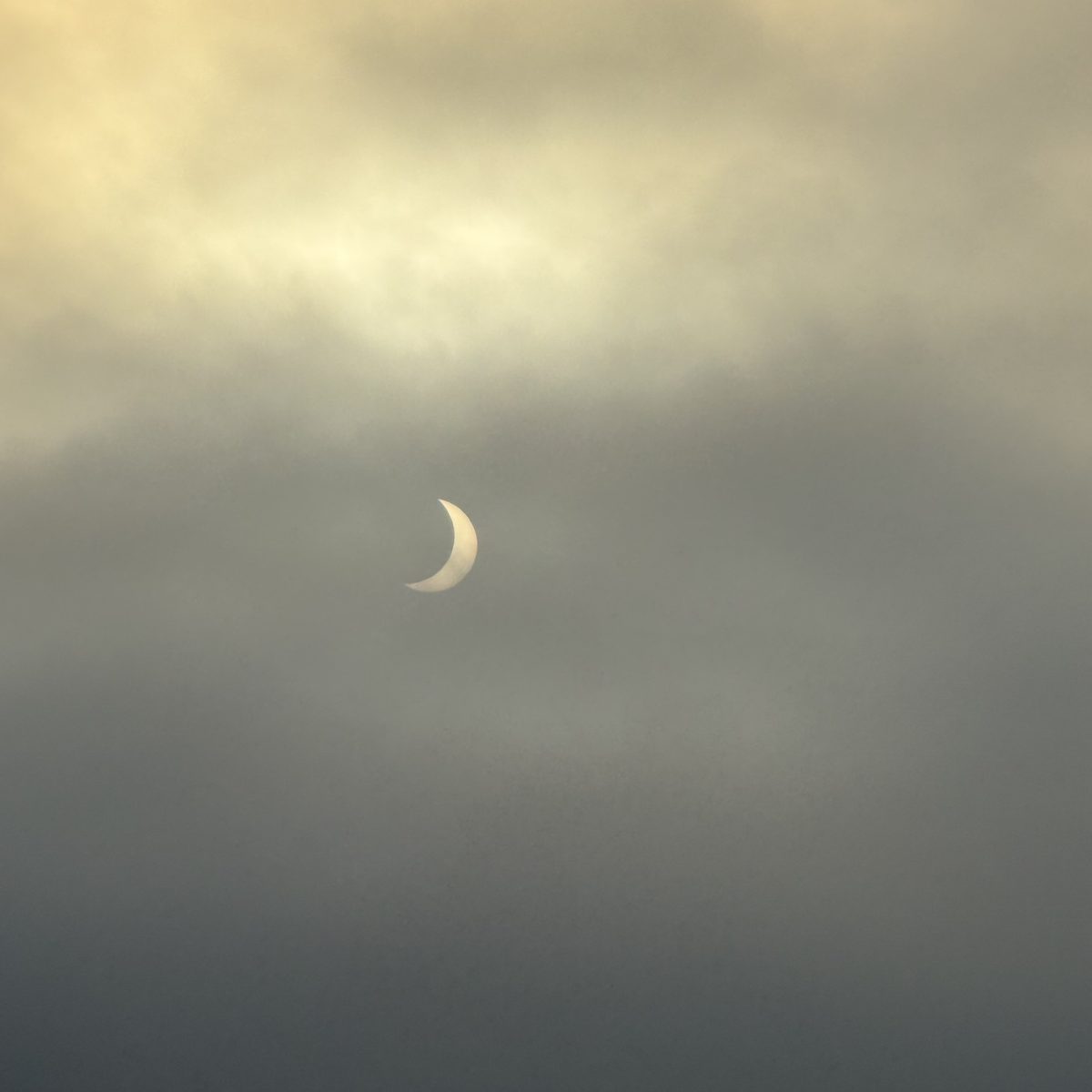 Dramatic crescent Sun through clouds during the 2026 eclipse in A Coruña